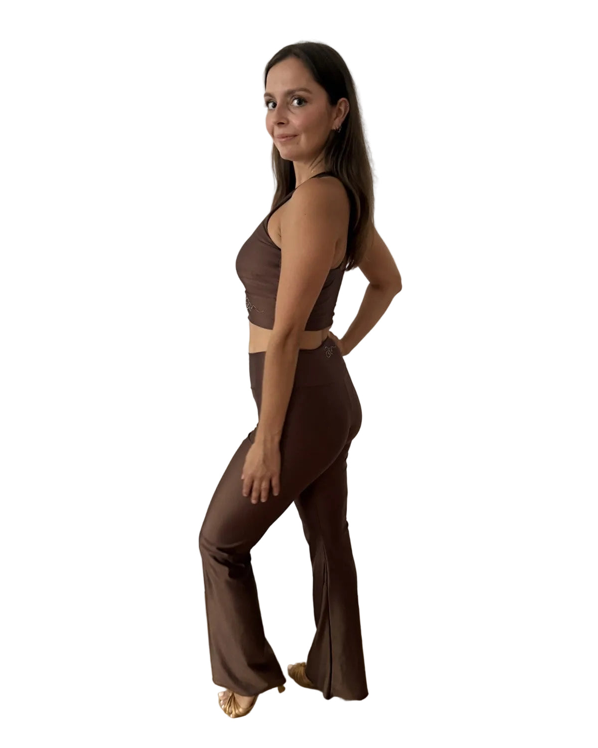 A woman modeling a matching two-piece activewear set in a solid dark brown color, featuring a halter crop top and high-waisted flared leggings dance set
