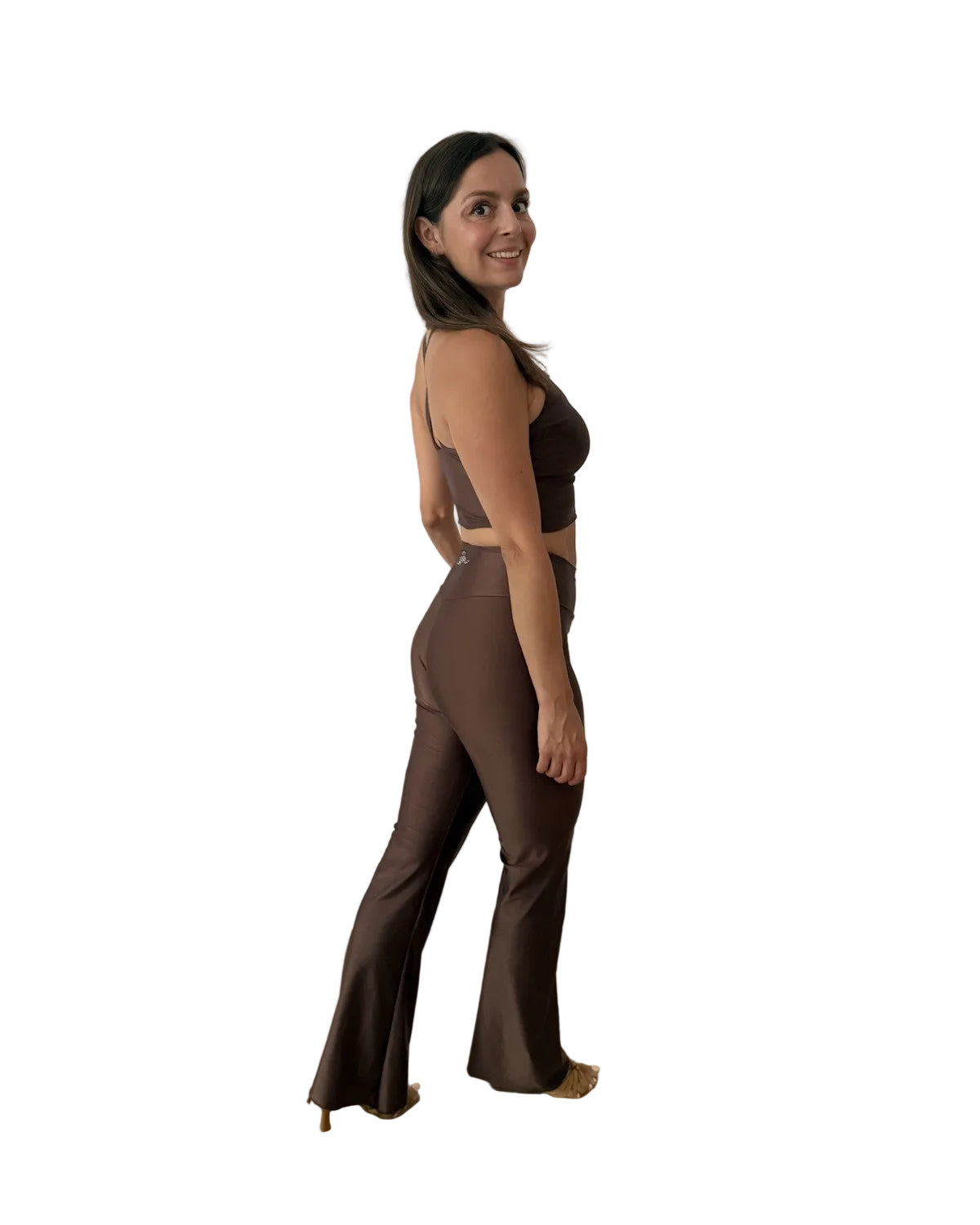 A woman modeling a matching brown activewear set consisting of a sports bra and high-waisted flared leggings dance set